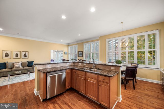 a kitchen with a stove sink and cabinets