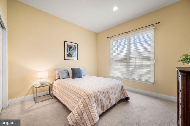 a bedroom with a bed and a chair