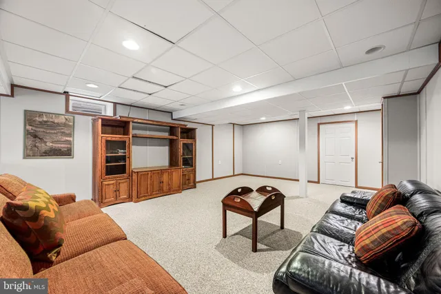 a spacious bedroom with a bed a couch and dresser