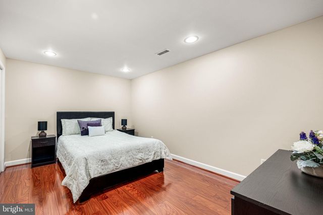 a bedroom with a bed and a potted plant