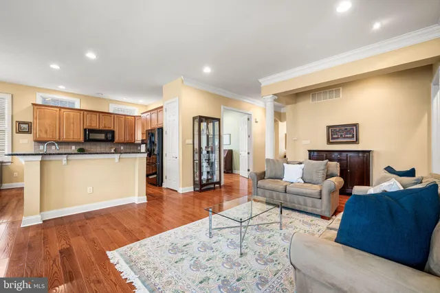 a living room with furniture and kitchen view
