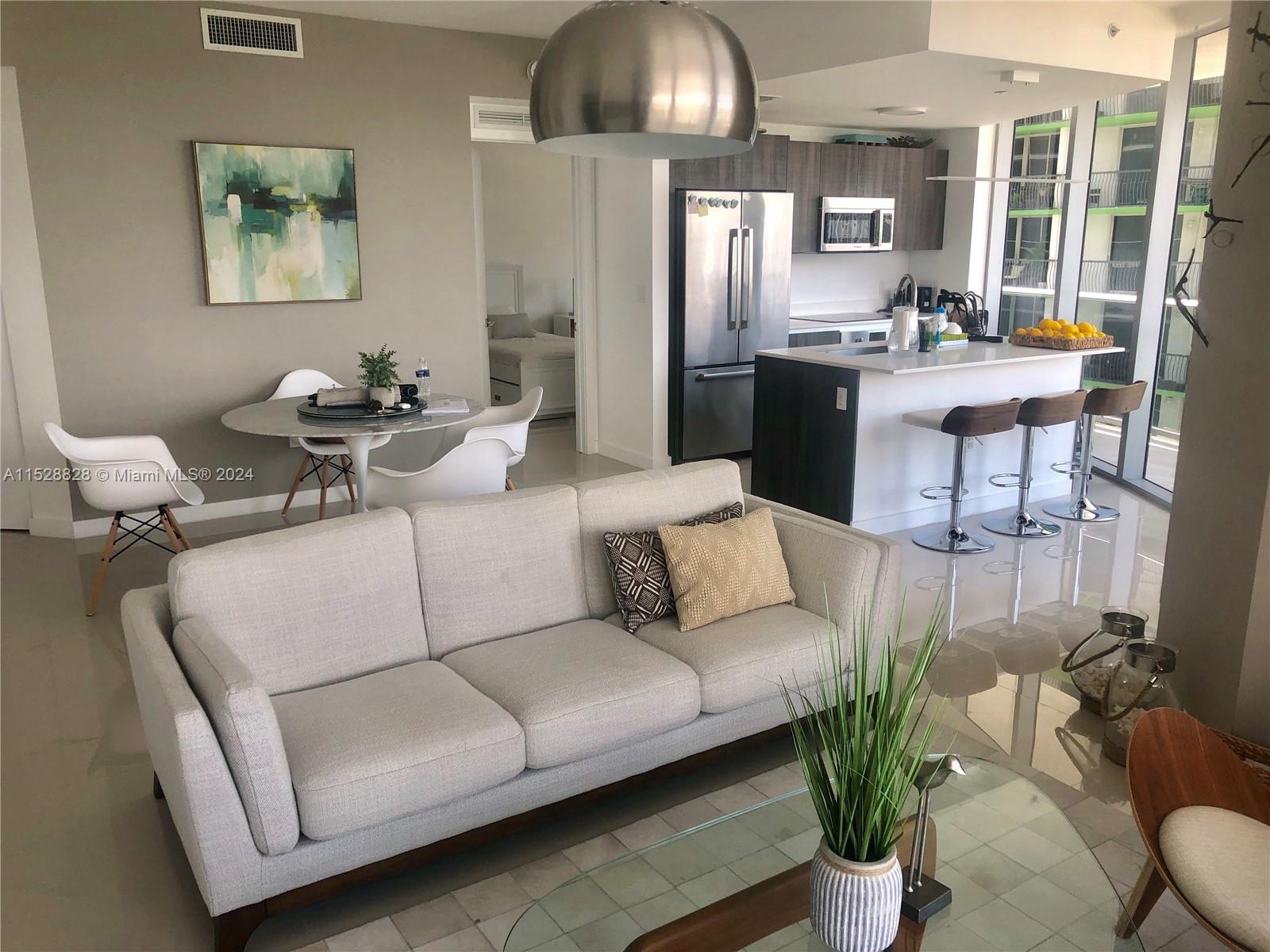 Edgewater Miami, FL 33132 - Photo 1 of 34 a living room with furniture and a chandelier