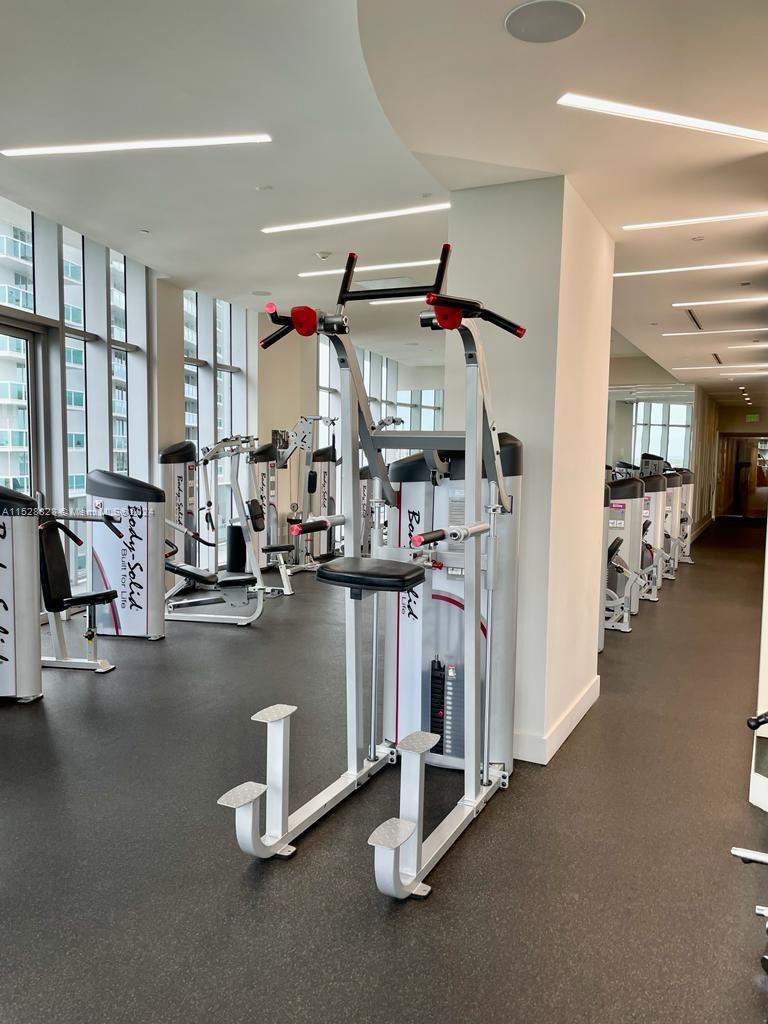Edgewater Miami, FL 33132 - Photo 31 of 34 a room with gym equipment and a large window