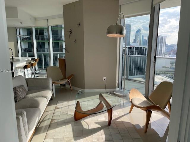 Edgewater Miami, FL 33132 - Photo 8 of 34 a living room with furniture and a floor to ceiling window