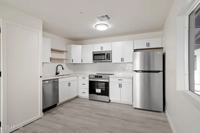 a kitchen with a refrigerator stove and sink