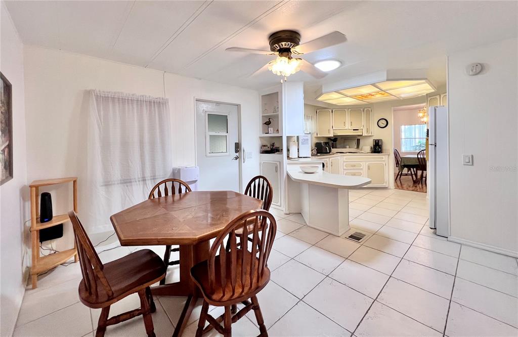 1100 South Belcher Road, Unit 663 Largo, FL 33771 - Photo 14 of 65 a dining room with furniture and chandelier
