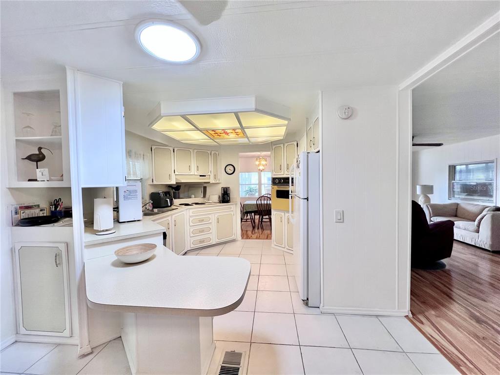 1100 South Belcher Road, Unit 663 Largo, FL 33771 - Photo 16 of 65 a kitchen with stainless steel appliances granite countertop a sink and a refrigerator