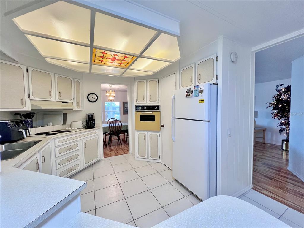 1100 South Belcher Road, Unit 663 Largo, FL 33771 - Photo 17 of 65 a kitchen with stainless steel appliances granite countertop a refrigerator and a stove top oven