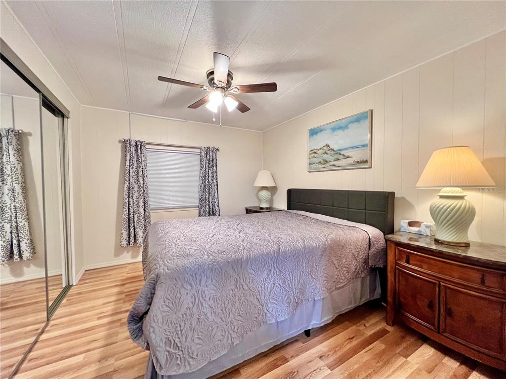 1100 South Belcher Road, Unit 663 Largo, FL 33771 - Photo 20 of 65 a bedroom with a large bed and a chandelier