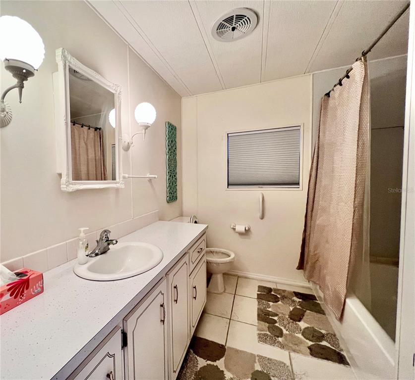 1100 South Belcher Road, Unit 663 Largo, FL 33771 - Photo 21 of 65 a bathroom with a sink a toilet a mirror and shower
