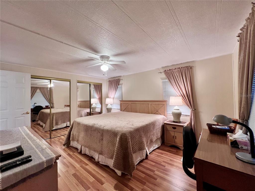 1100 South Belcher Road, Unit 663 Largo, FL 33771 - Photo 24 of 65 a bedroom with a bed and wooden floor