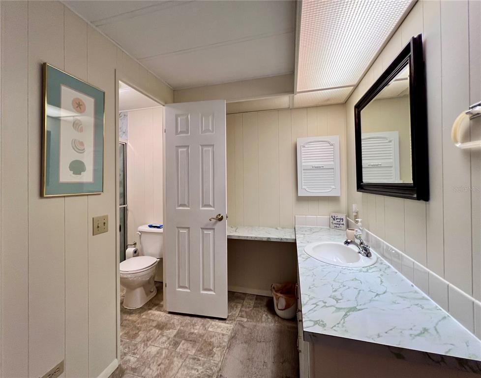 1100 South Belcher Road, Unit 663 Largo, FL 33771 - Photo 28 of 65 a spacious bathroom with a granite countertop sink and a mirror