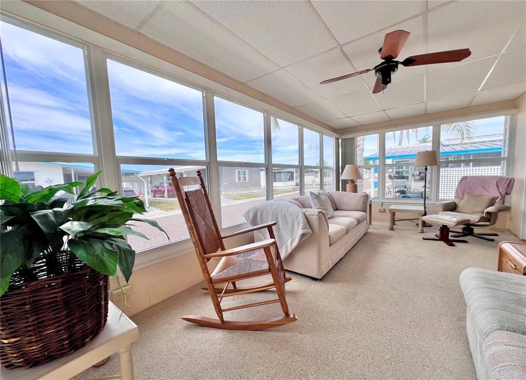 1100 South Belcher Road, Unit 663 Largo, FL 33771 - Photo 5 of 65 a living room with furniture and a floor to ceiling window