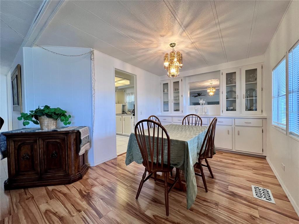 1100 South Belcher Road, Unit 663 Largo, FL 33771 - Photo 9 of 65 a view of a dining room with furniture and chandelier