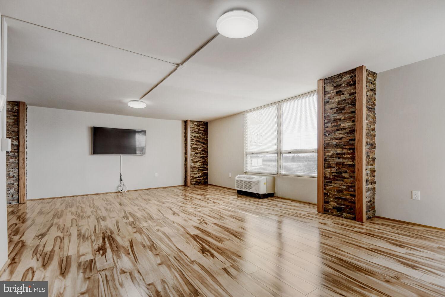 LR with new hardwood floors and exposed brick