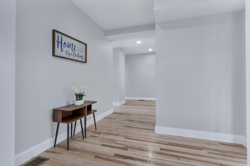 73 Walnut Street Dedham, MA 02026 - Photo 13 of 35 a view of a hallway with wooden floor