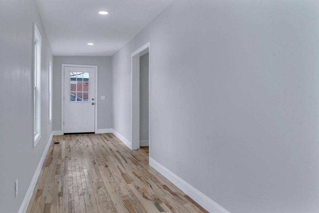 73 Walnut Street Dedham, MA 02026 - Photo 14 of 35 a view of a hallway with wooden floor