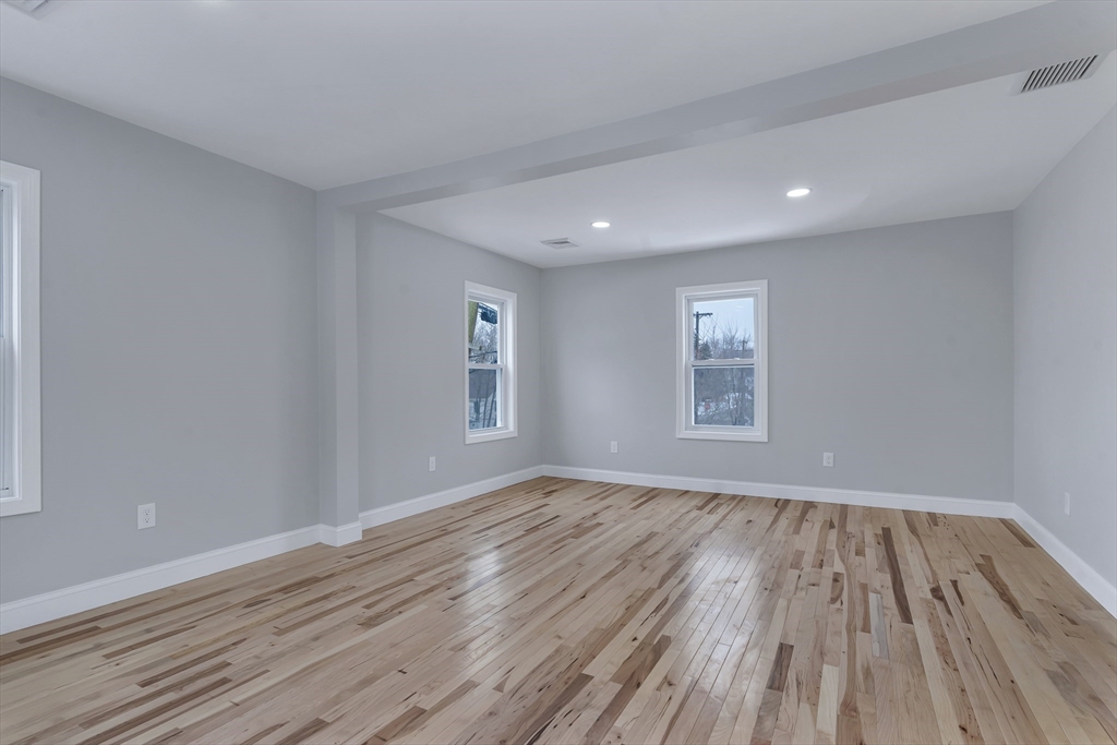 73 Walnut Street Dedham, MA 02026 - Photo 17 of 35 a view of an empty room with wooden floor and a window