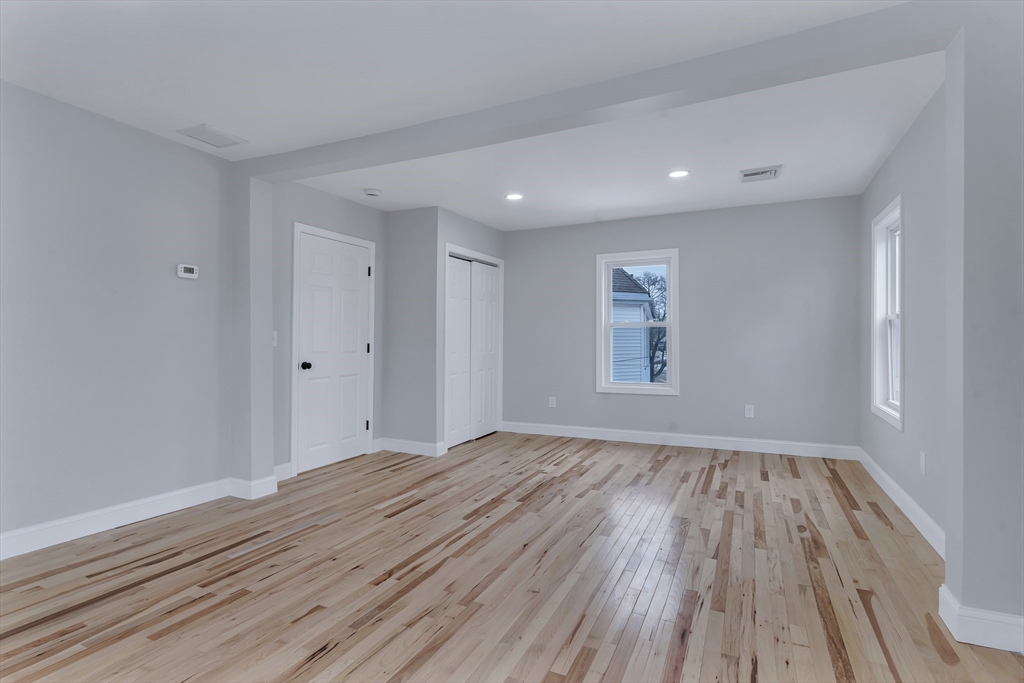 73 Walnut Street Dedham, MA 02026 - Photo 18 of 35 a view of an empty room with wooden floor