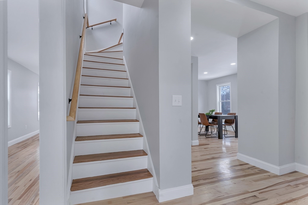 73 Walnut Street Dedham, MA 02026 - Photo 19 of 35 a view of dining room with stairs and wooden floor