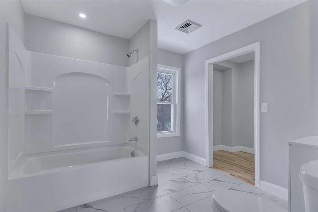 73 Walnut Street Dedham, MA 02026 - Photo 20 of 35 a spacious bathroom with a bathtub and shower