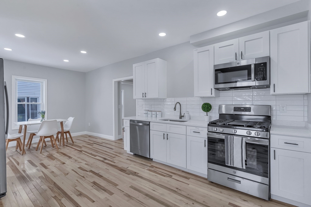 73 Walnut Street Dedham, MA 02026 - Photo 2 of 35 a kitchen with stainless steel appliances granite countertop a stove a sink and a microwave