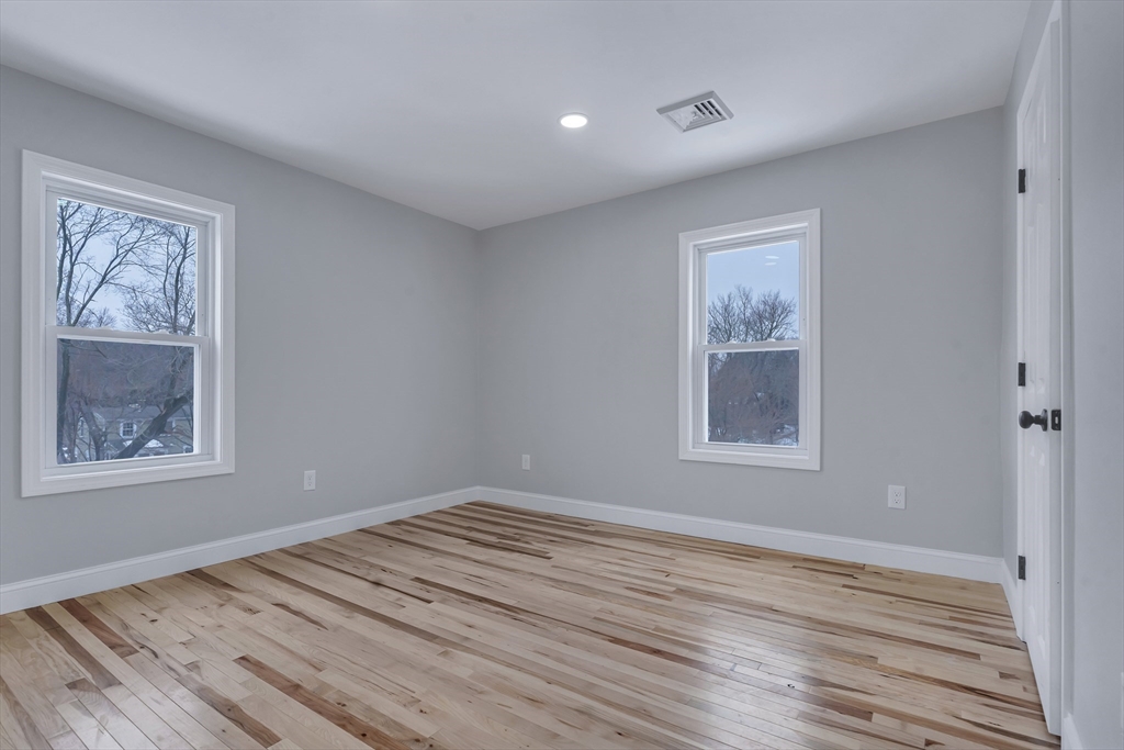 73 Walnut Street Dedham, MA 02026 - Photo 23 of 35 a view of empty room with window and wooden floor