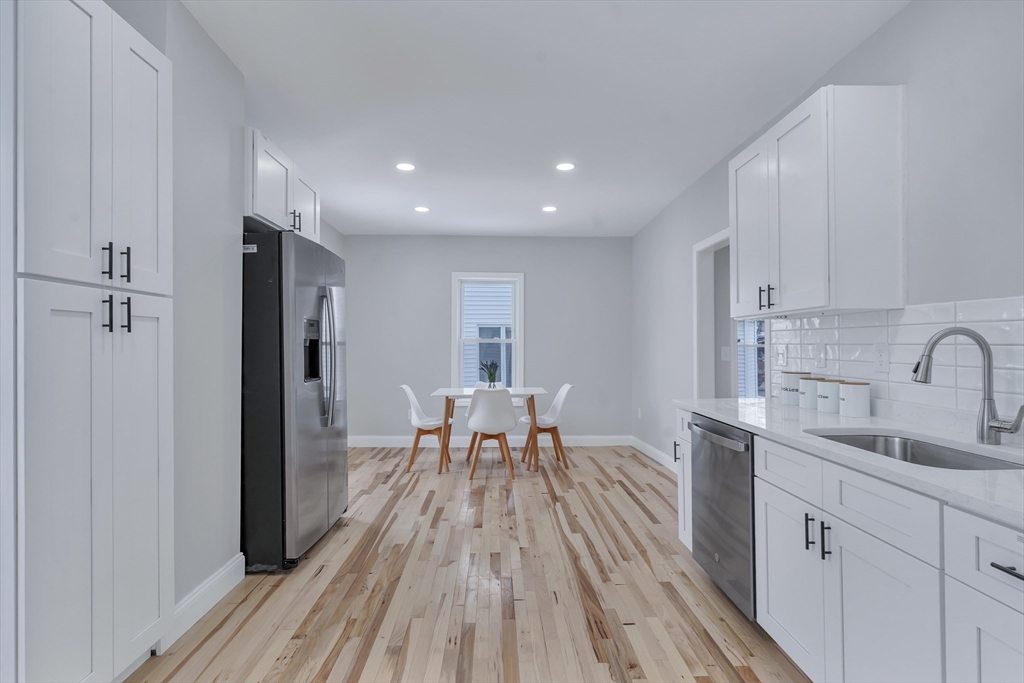 73 Walnut Street Dedham, MA 02026 - Photo 7 of 35 a view of a kitchen with a sink and wooden floor