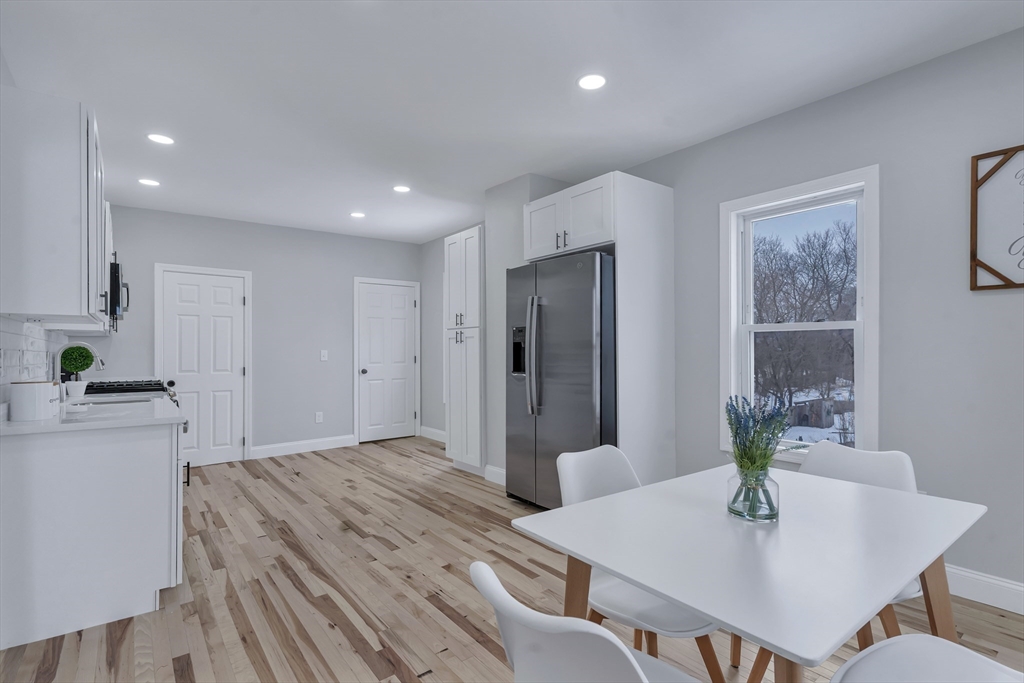 73 Walnut Street Dedham, MA 02026 - Photo 8 of 35 a kitchen with a table and chairs