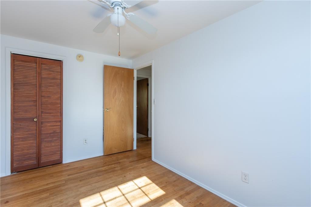 419 Manor Road Delmont, PA 15626 - Photo 25 of 30 a view of a room with wooden floor and ceiling fan