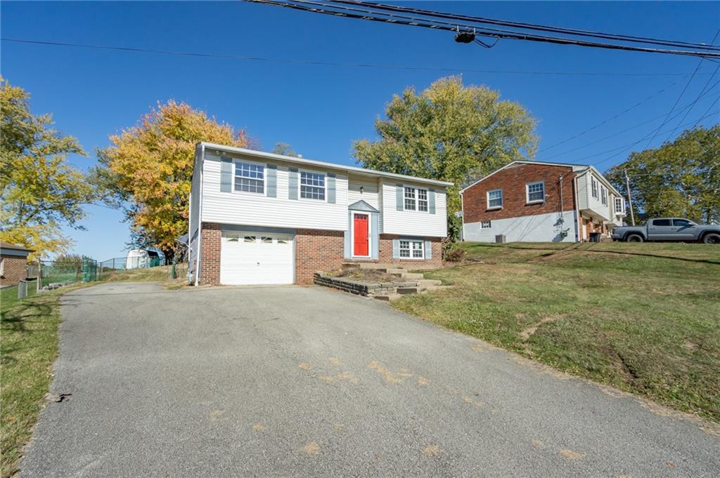 419 Manor Road Delmont, PA 15626 - Photo 4 of 30 a front view of a house with a yard and garage