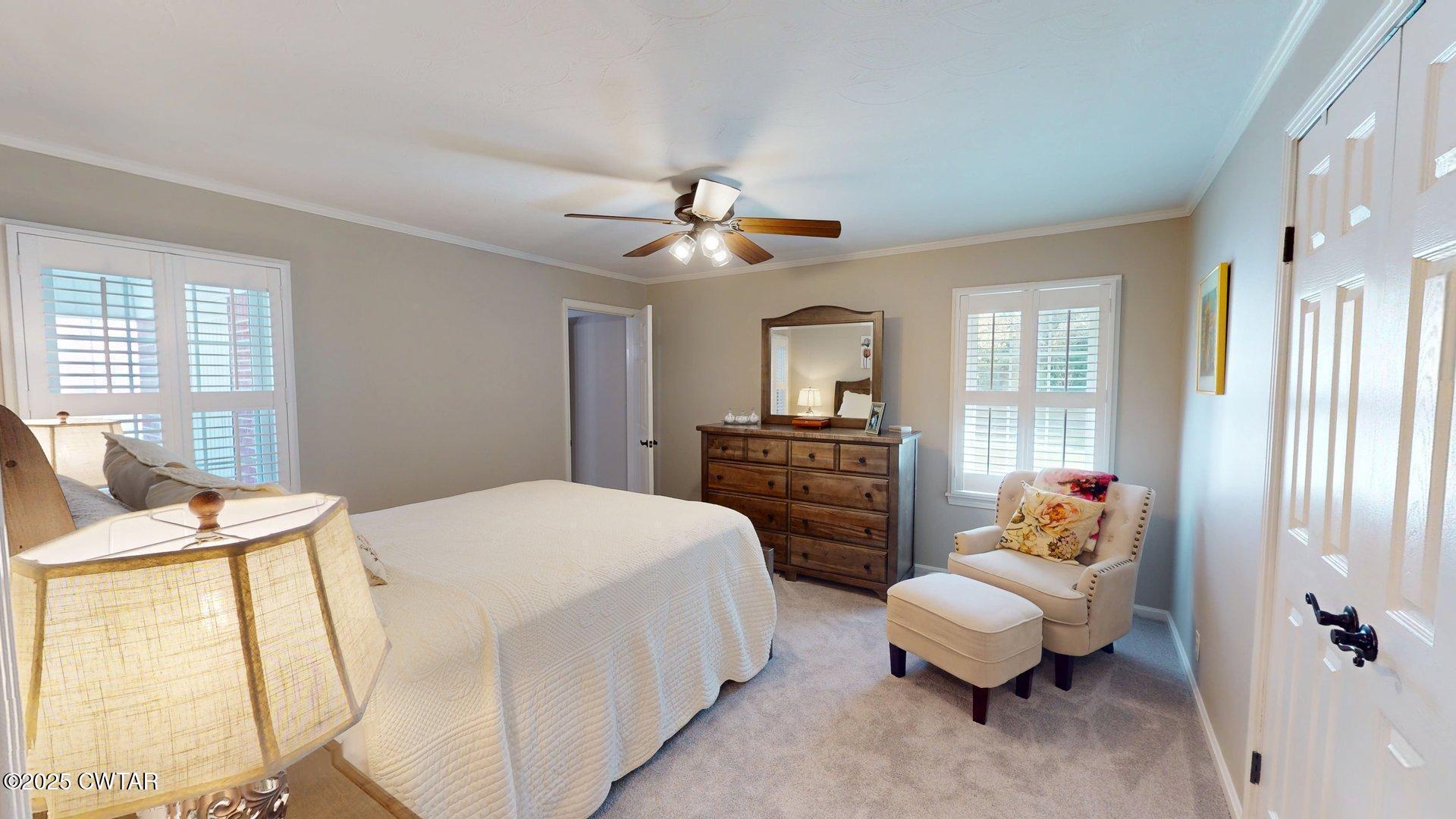 302 Flora Circle Newbern, TN 38059 - Photo 18 of 26 a bed room with a bed and a chandelier