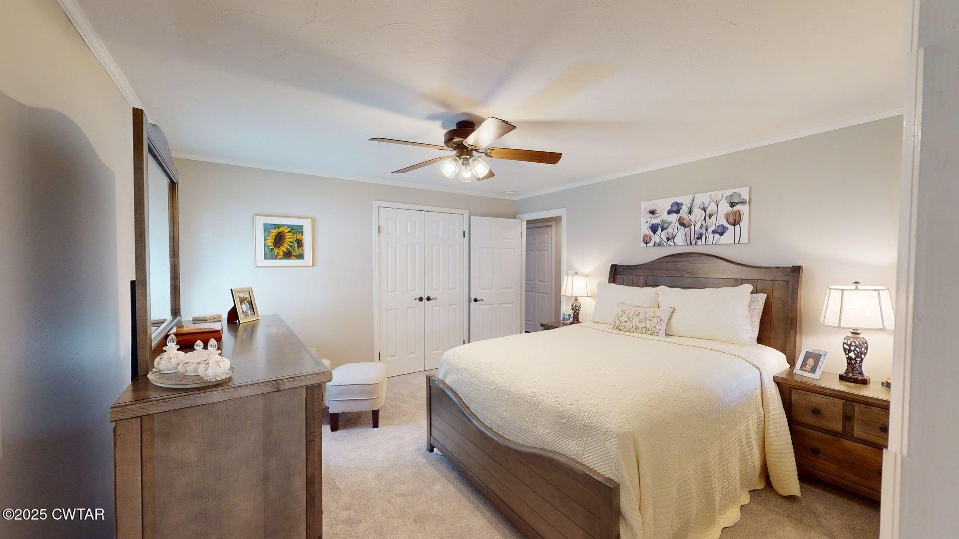 302 Flora Circle Newbern, TN 38059 - Photo 20 of 26 a bedroom with bed and a chandelier