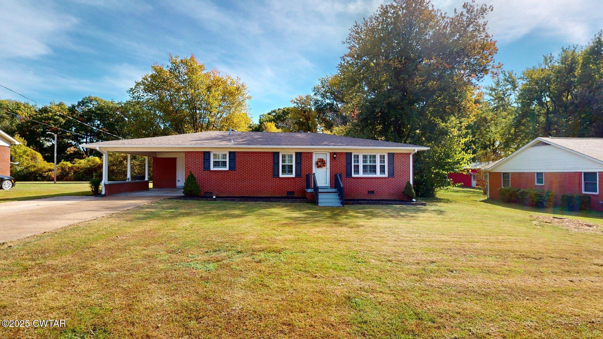 302 Flora Circle Newbern, TN 38059 - Photo 2 of 26 a view of a house with a swimming pool