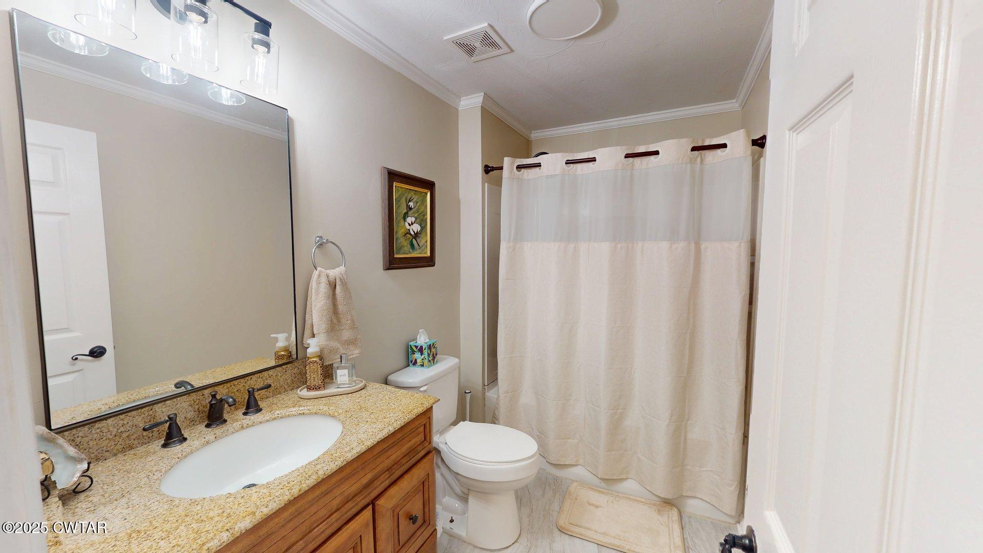 302 Flora Circle Newbern, TN 38059 - Photo 22 of 26 a bathroom with a granite countertop sink toilet and shower