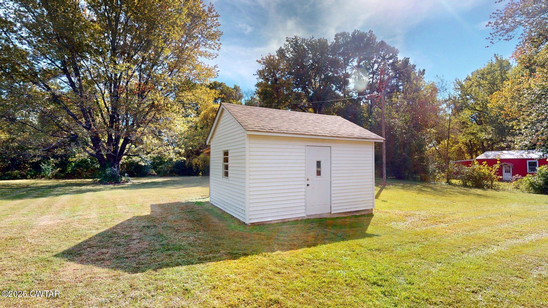 302 Flora Circle Newbern, TN 38059 - Photo 24 of 26 a view of backyard of house with trees