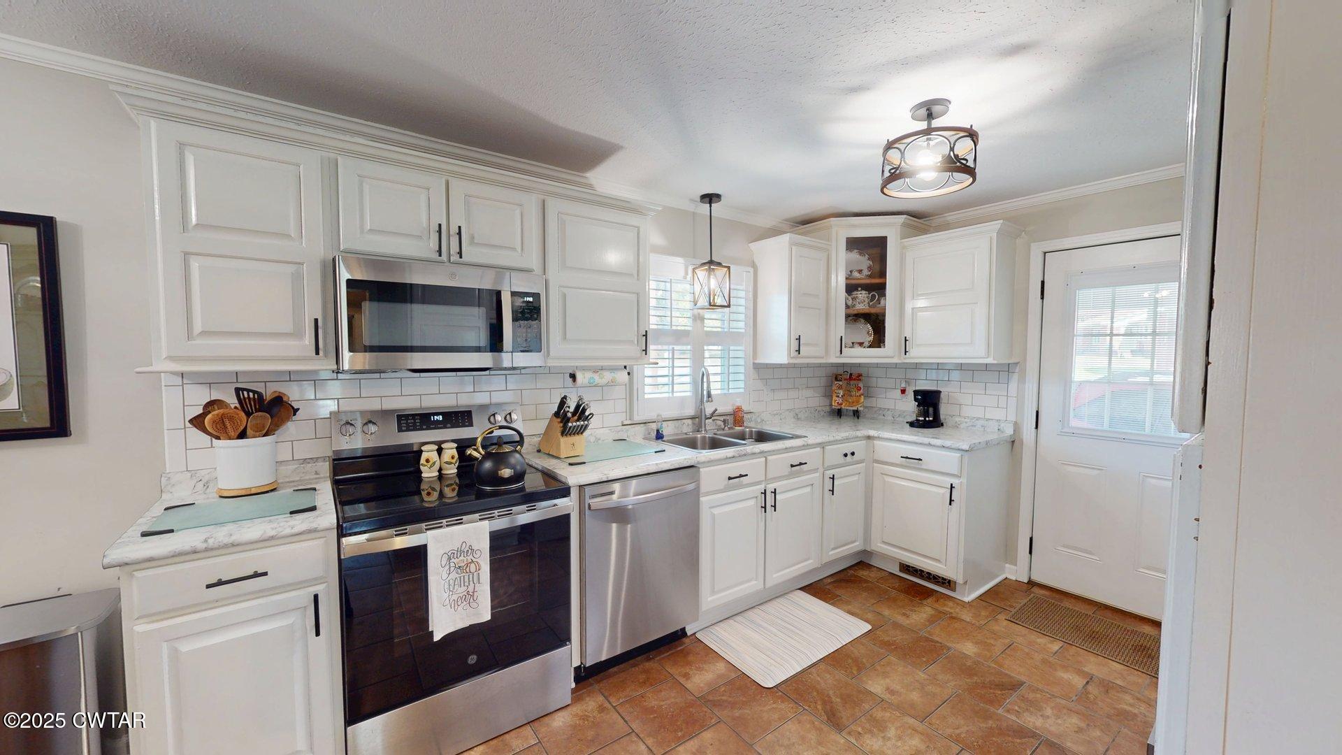 302 Flora Circle Newbern, TN 38059 - Photo 10 of 26 a kitchen with cabinets appliances cabinets and a sink