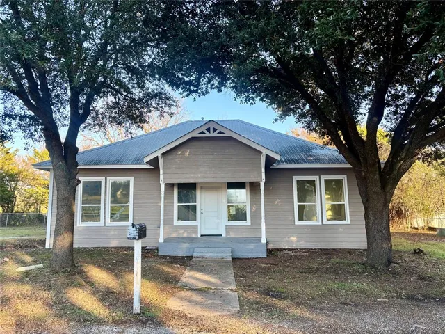 a house with trees in the background