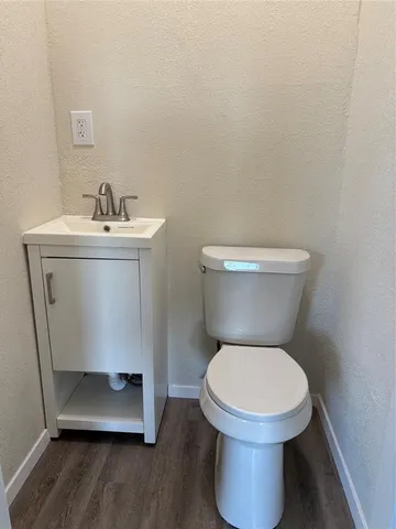 a white toilet sitting next to a bathroom sink