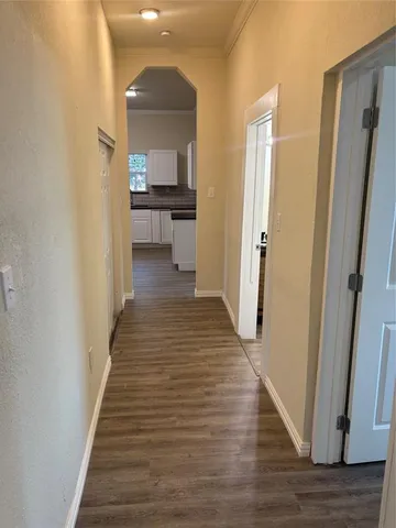 a view of a hallway view with wooden floor and staircase
