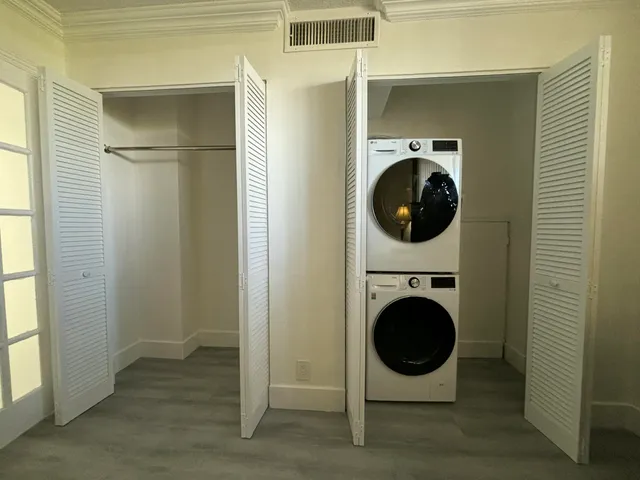 a view of a hallway with washer and dryer