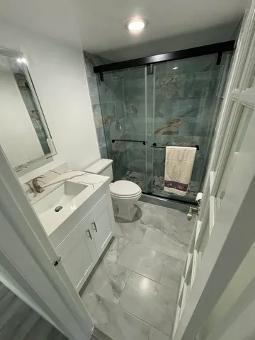 a bathroom with a sink toilet and shower