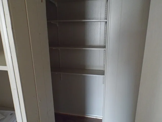 a kitchen with a refrigerator sink and cabinets