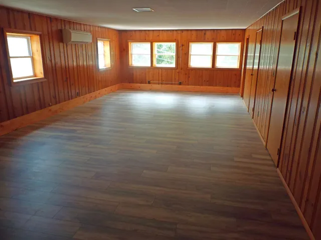 a view of hallway with wooden floor