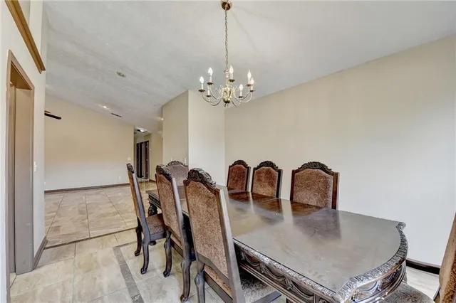 a view of a dining room with furniture and chandelier