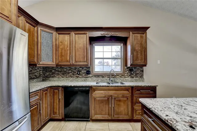 a kitchen with granite countertop a stove and a sink