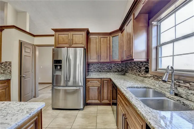 a kitchen with granite countertop a stove sink and microwave