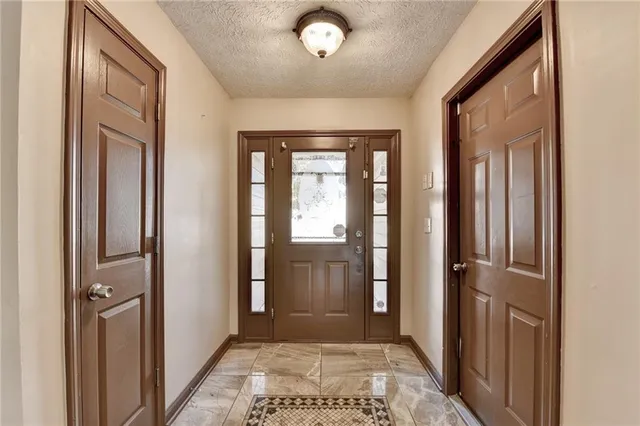 a view of a hallway with a glass door and a window