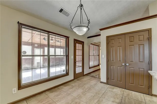 a kitchen with stainless steel appliances granite countertop a stove top oven a sink and dishwasher