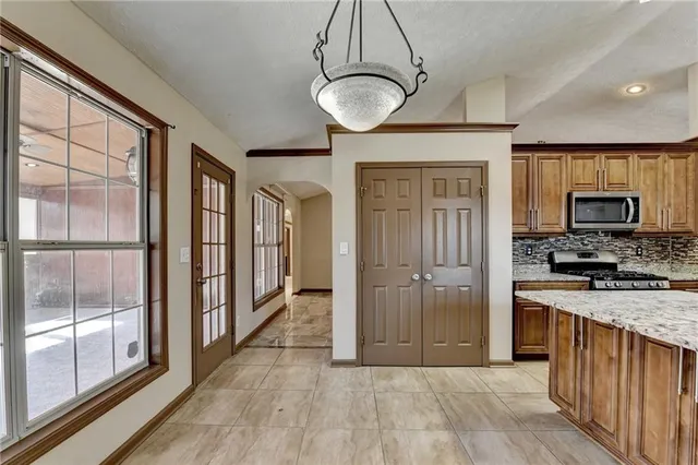 a view of a kitchen with a sink and dishwasher with wooden floor
